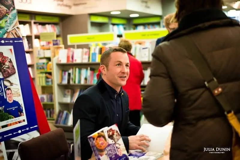 Pat signing copies of Naked Paleo in a bookshop