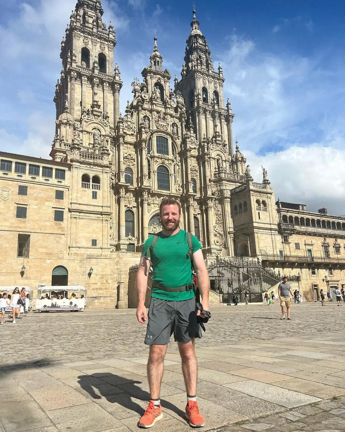 Pat standing in front of the cathedral in Santiago de Compostela at the end of the Camino