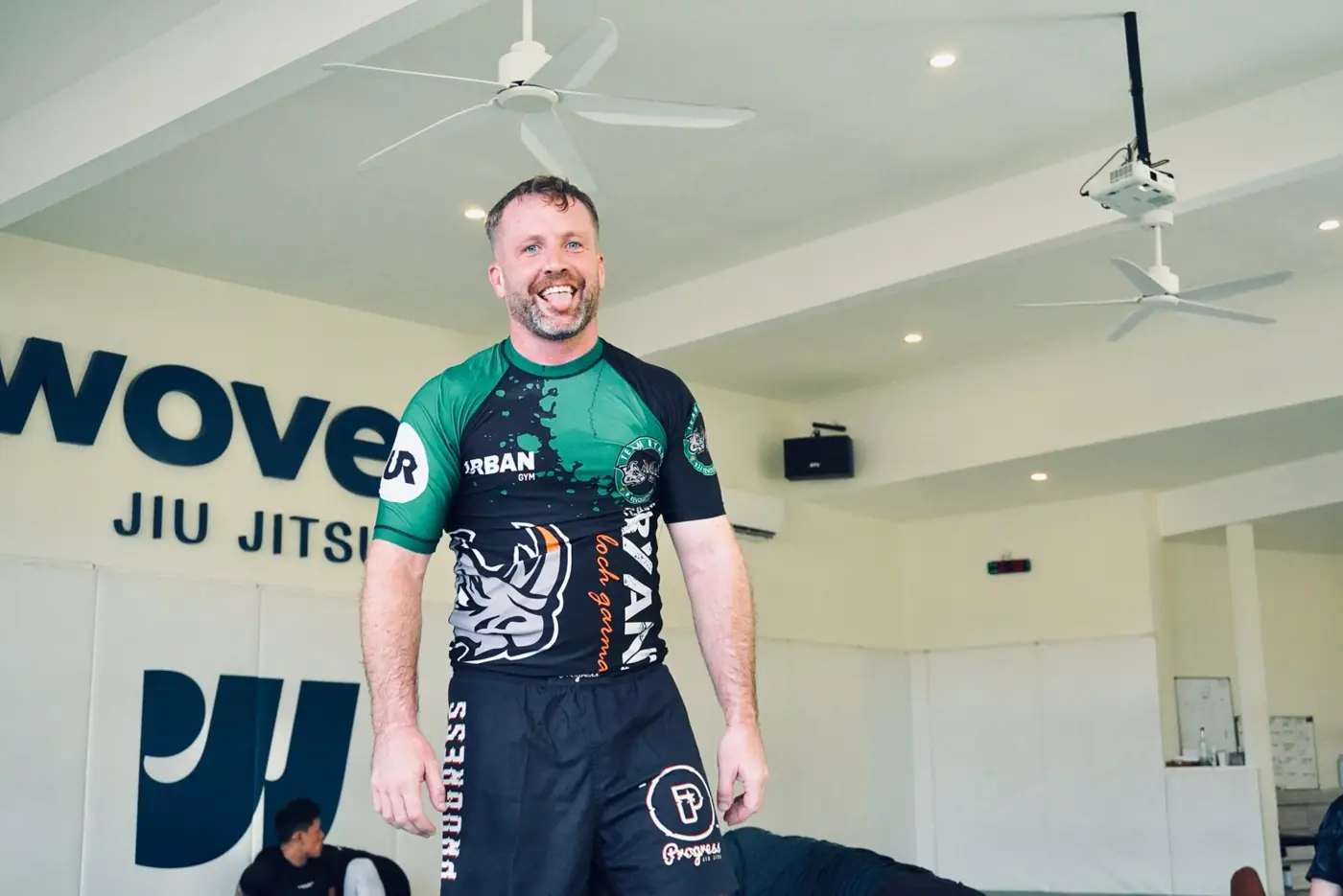 Pat grinning with his tongue out on the jiu-jitsu mats