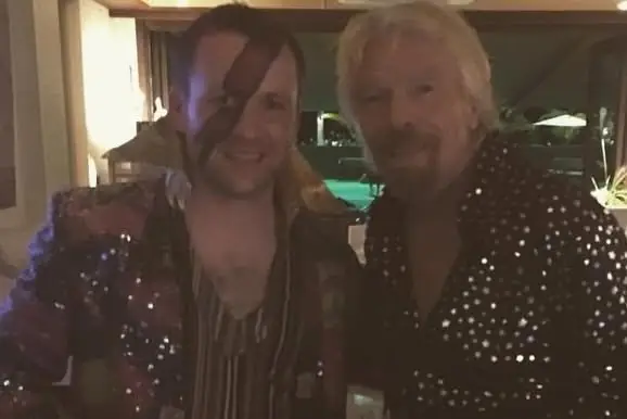 Pat with Richard Branson at a fancy-dress party, both in sequinned shirts