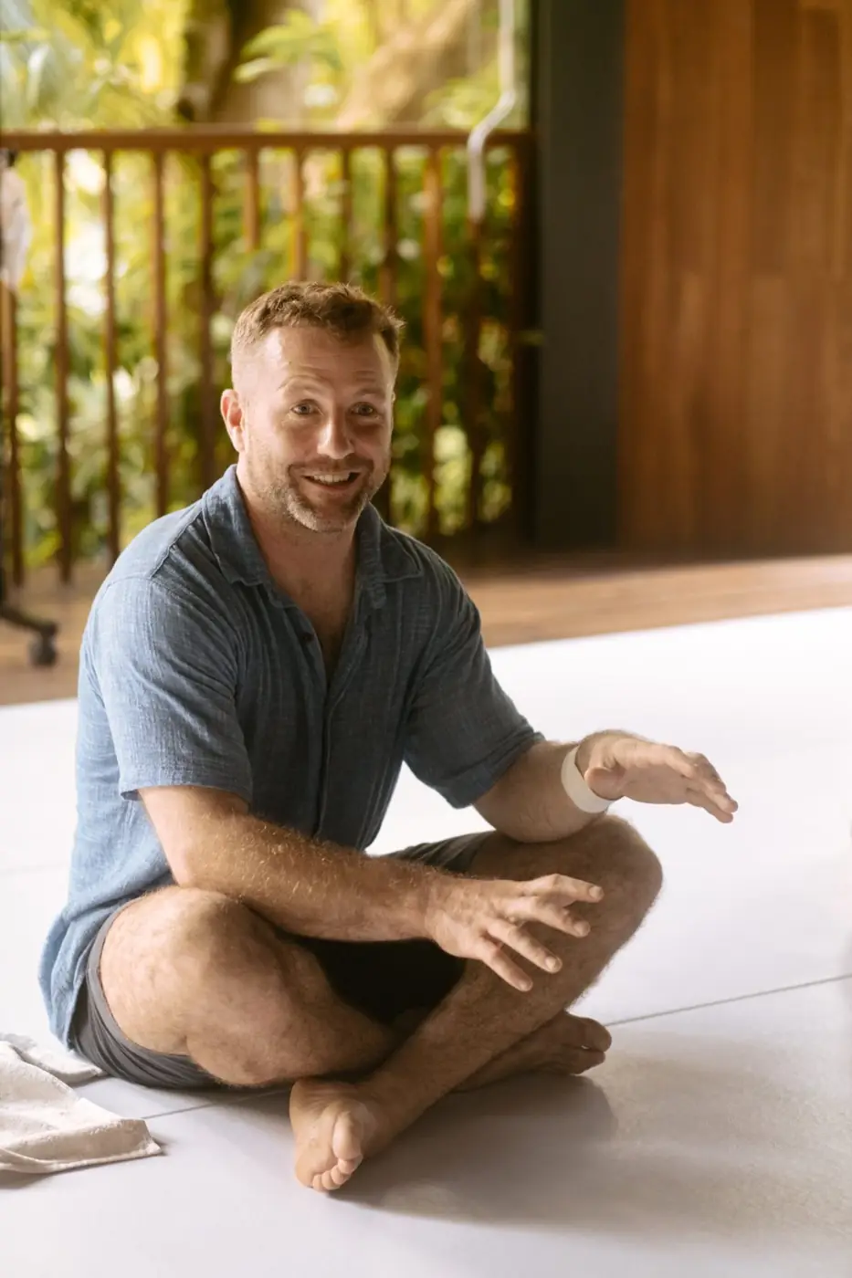 Pat sitting cross-legged on a mat, teaching